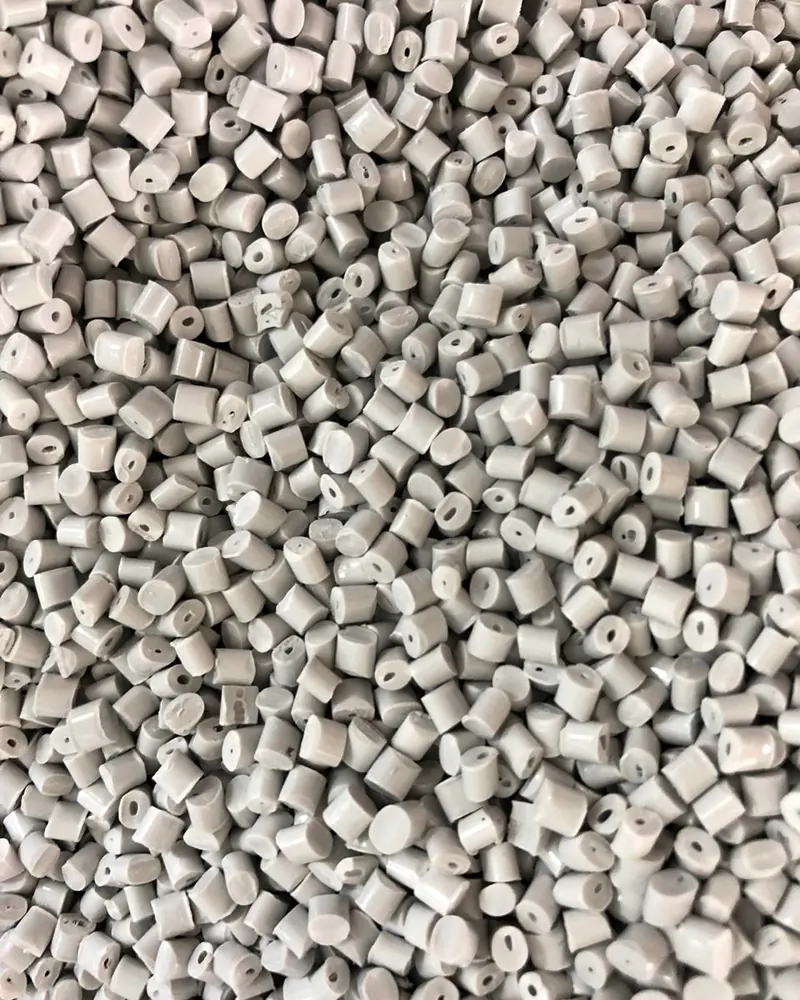 Densely packed grey cylindrical polymer pellets