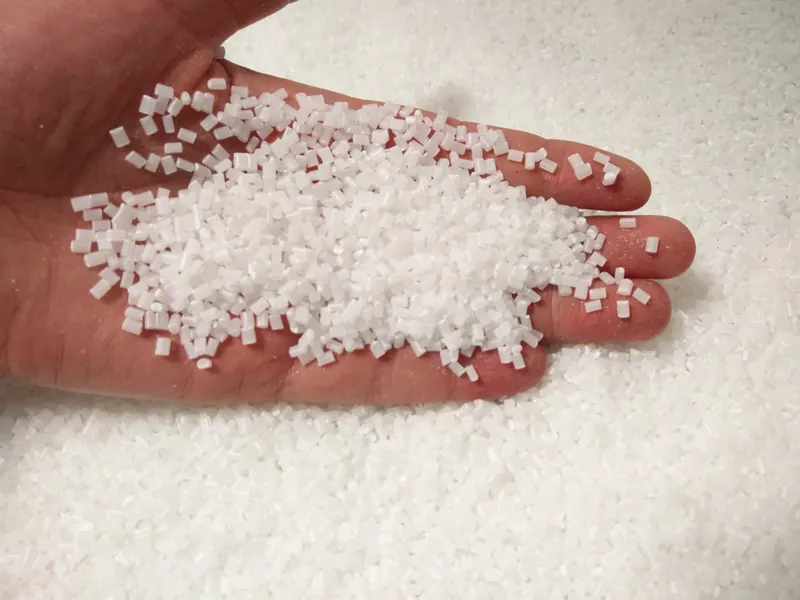 Natural, translucent polymer granules held in an open hand